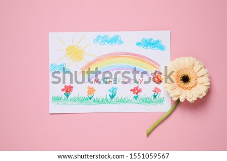 Handmade greeting card for Mother's Day and flower on pink background, flat lay