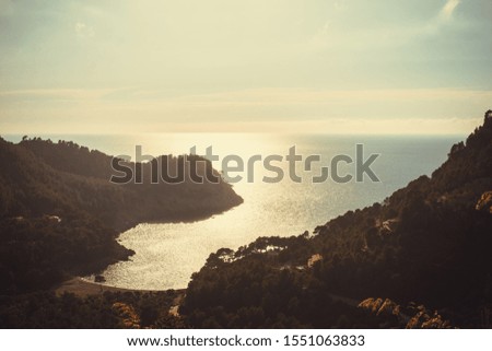 Panoramic aerial view of a beach in a very bright sunset
