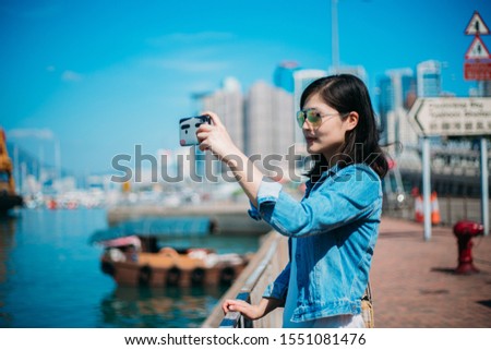 Asian woman traveling in Hong Kong on Causeway Bay Waterfront