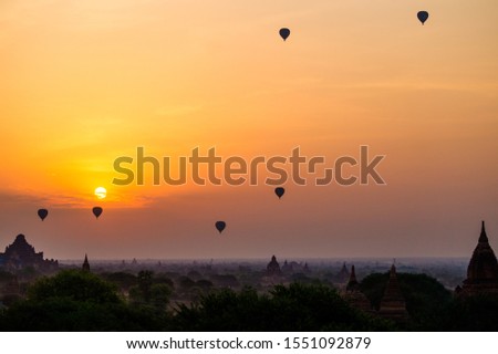 temples and many hot air balloons in bagan myanmar during sunrise