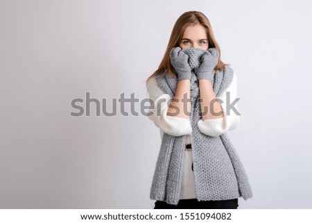 The girl in gloves covered her face with a scarf