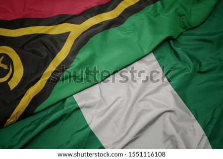waving colorful flag of nigeria and national flag of Vanuatu . macro