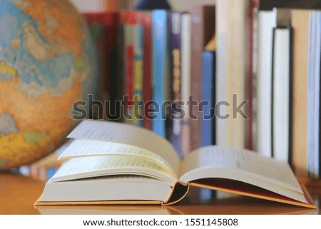 Close-up of of open books on the table Books arranged in the background selective focus and shallow depth of field