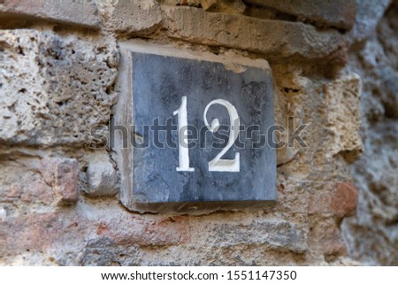 Number 12 on a wall of a house in Pompei Italy