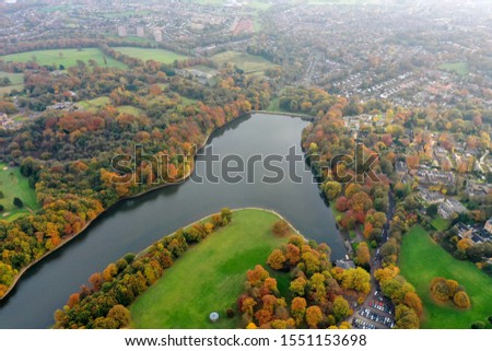 Aerial photo in autumn showing the beautiful autumn colours of a park and lake in Leeds known as Roundhay Park in West Yorkshire UK