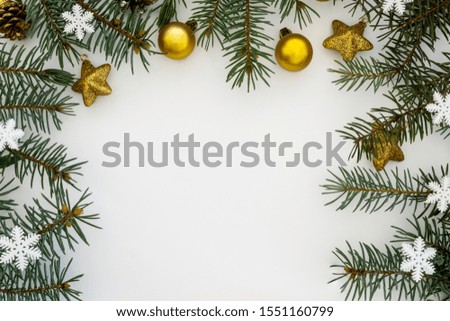 Creative Composition Useful for Christmas and New Year Greeting Card Created Using Decorative Balls, Snowflakes, Stars and Green Pine Branches. Copy Space in The Middle