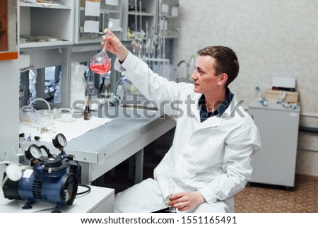 male scientist conducts chemical experiments in medical laboratory