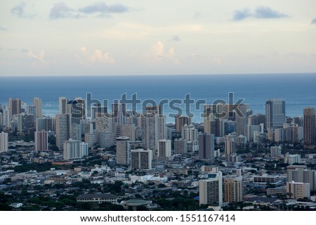 Aerial of Honolulu, Waikiki, Buildings, parks, hotels and Condos with Pacific Ocean stretching into the distance on nice day. 