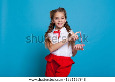 schoolgirl with two pigtails on a blue background