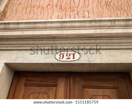 Number 921 on a wall of a house in Venice Italy 