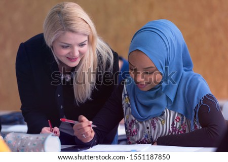 Female Architecture teacher at work. Female professor explain architectural projects to students. Beautiful female university architecture professor smiling into camera.