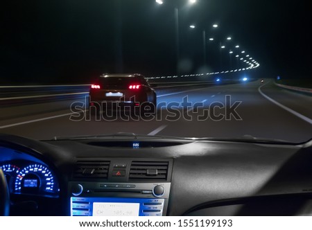 view from moving car on highway at night