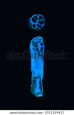Close-up of abstract blue letter I made from blots on a black background.