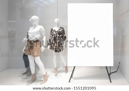 Mockup of blank white vertical indoor advertising poster stand at the storefront window in shopping centre or mall