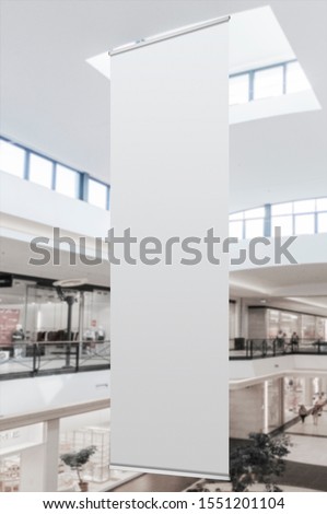 Mockup of blank white vertical indoor advertising flag hanging in shopping centre or mall