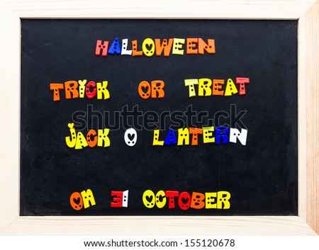 Color halloween words on clip board. words on black board.
