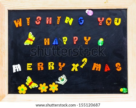Color merry christmas words on black board.
