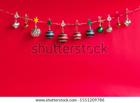 Christmas  decorations  hanging  on  the  rope  with  red  background