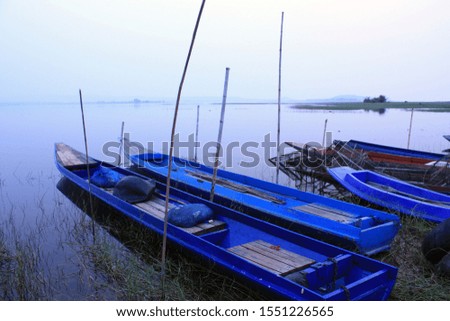 
Photos of the boat parked by fishermen. Take fish in the big lagoon at Summer holidays and holidays and relaxation Nature background