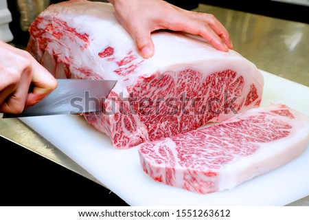 Chef cutting raw Japanese  wagyu beef Royalty-Free Stock Photo #1551263612