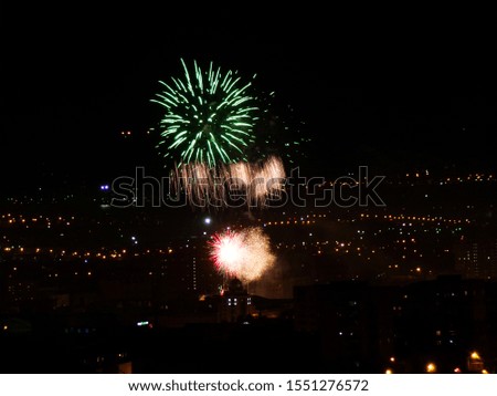 Beautiful fireworks on the feast day of the city. spectacular show of fireworks. Pyrotechnics for the new year. Explosions of fireworks on the background of the night city.