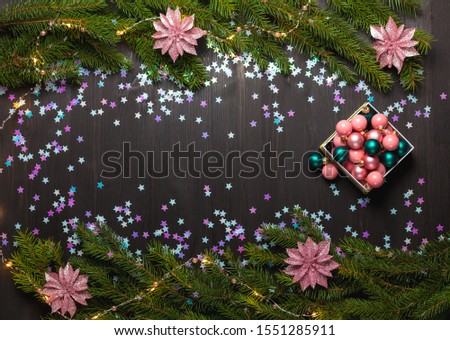 Christmas fir tree with garland. Flat lay, top view, copy space. Decorative frame of fir branches and Christmas decorations