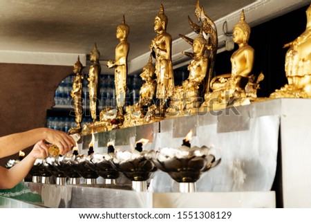 Lighting the candle pray to Buddha, Oil Lamp in the Buddhism Temple.