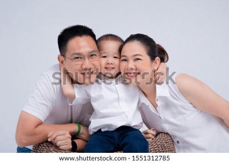 Chinese=Thai  family :  little kid hold his parent together for taking  picture
