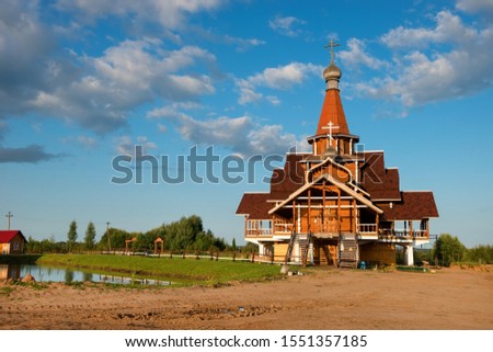 The Church of German Stolobensky in Sosnici on a summer evening at sunset. Built in the style of Novgorod wooden churches.
