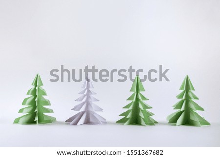 Christmas concept. Origami paper Christmas trees on white background.