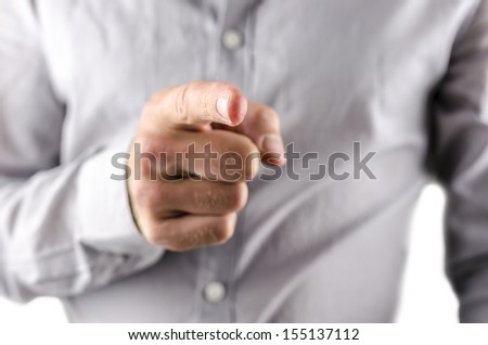Closeup of businessman pointing finger at you.