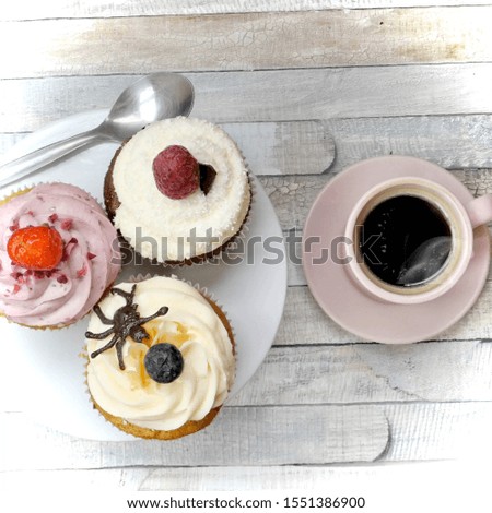 The photo from the top view of the three flavored cupcakes served with a black coffee in a pink glass and changed a little romantic picture style-image