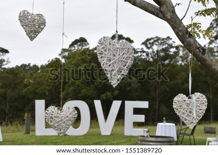 Hanging woven hearts in front of love