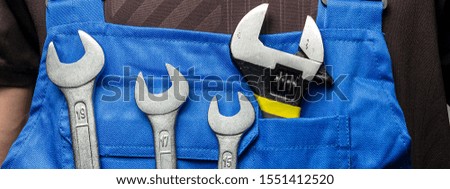 Handyman in uniform with construction tools and  equipments. Men tools background. Panoramic banner. 