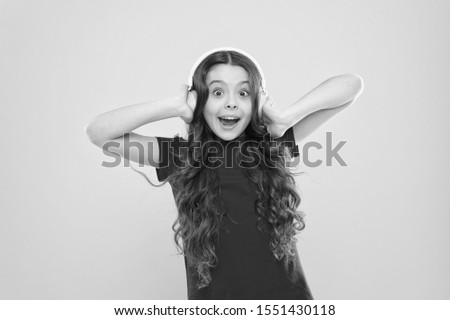 Give in to the groove. Little DJ on yellow background. Cute girl listening to music in DJ headphones. Small child using wireless headset for DJ disco. Adorable kid enjoying DJ tune playing in radio.