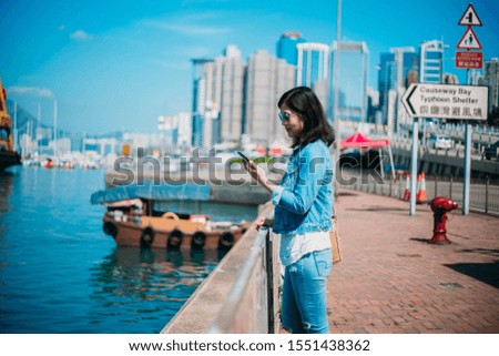 Asian woman traveling in Hong Kong on Causeway Bay Waterfront