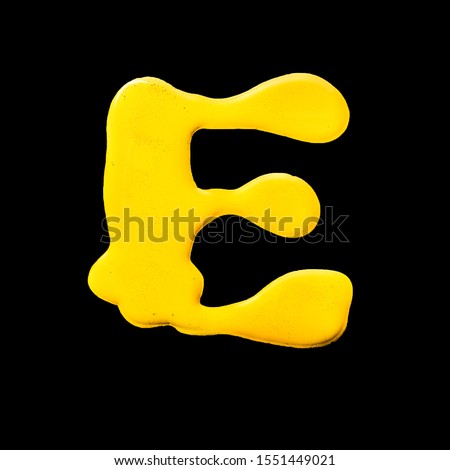 Latin alphabet . yellow letter E  on a black background. gouache.