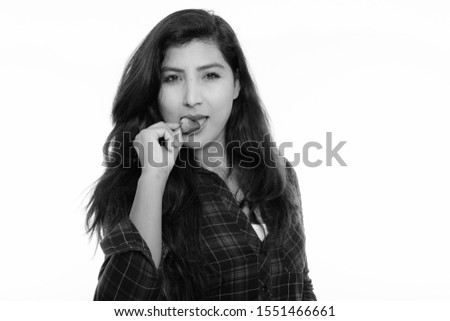 Close up of young beautiful Persian woman eating strawberry