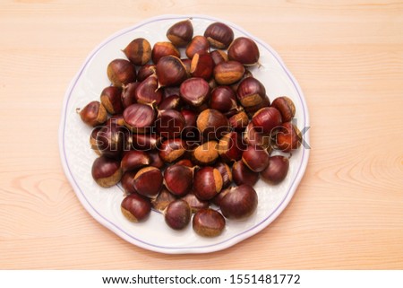 plate full of chestnuts on wood