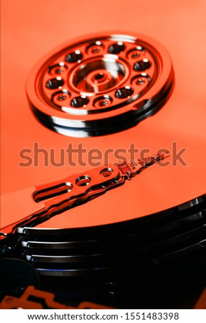 The hard disk from the computer HDD is red, with a mirror effect. The hard drive from the computer has opened.