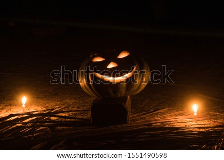  a  pumpkin evil face shape with two candle in halloween celebration time . a halloween pumpkin .