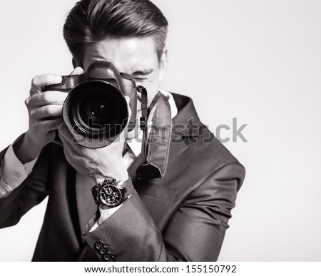 Photographer man is using professional camera