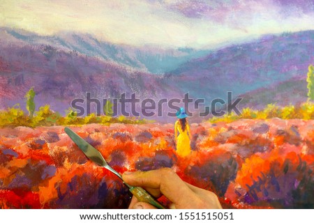 Artist hand with a brush closeup paints a beautiful picture paintntg artwork on canvas