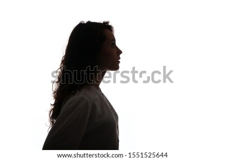 Silhouette portrait of a beautiful young girl with long hair isolated on white background