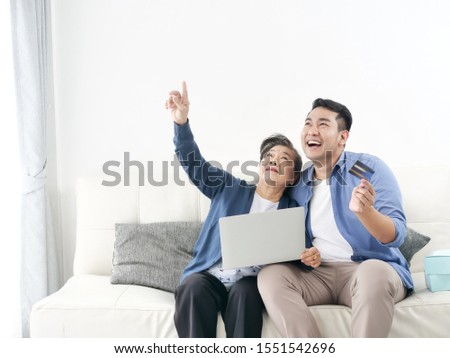 Asian man teaching his mother for shopping online, modern lifestyle concept.