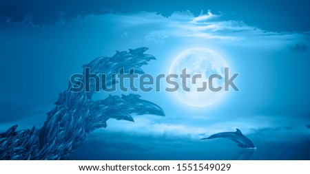 Abstract background of group of dolphins jumping on the water -     Night sky with moon in the clouds "Elements of this image furnished by NASA"
