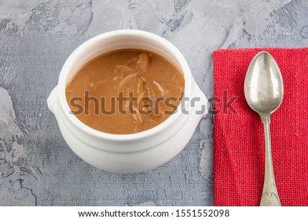 Famous French dish, French onion soup. Caramelised onions cooked in stock with wine and herbs, topped with toasted baguette and cheese and finished under the grill.