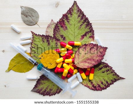 The autumn cold. Medicines on fallen leaves