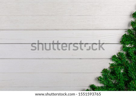 Fir branches on white wooden board. Christmas or New year background