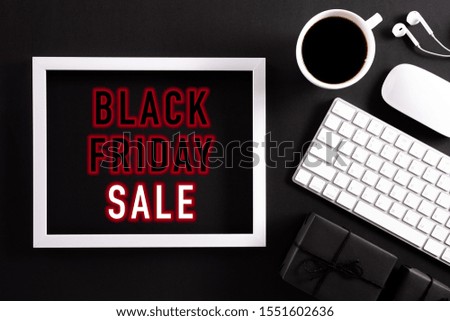 Black Friday Sale text on white picture frame with keyboard mouse coffee cup, gift box on white background. Online Shopping concept and black Friday composition.